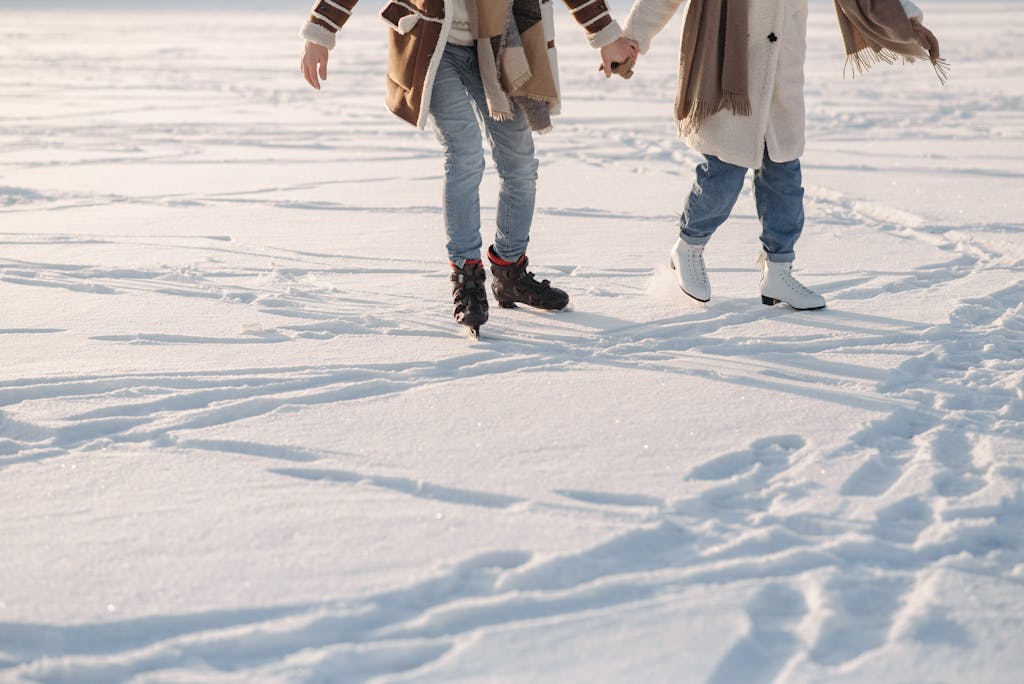 A Couple Holding Hands while Ice Skating