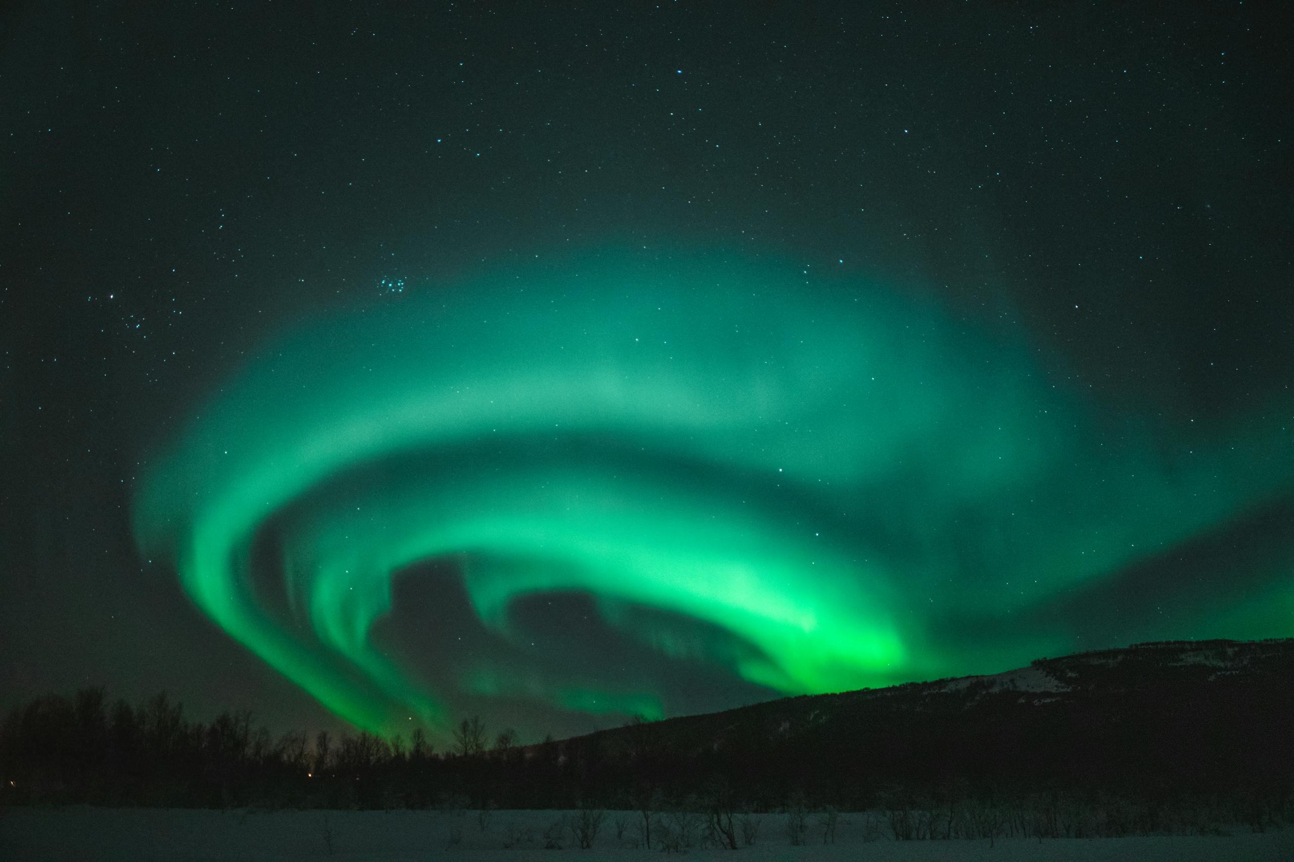Glowing Green Lights on Black Sky