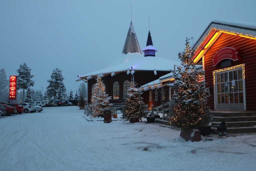 A festive twilight scene of Santa Claus Village in snowy Rovaniemi, Lapland, Finland.